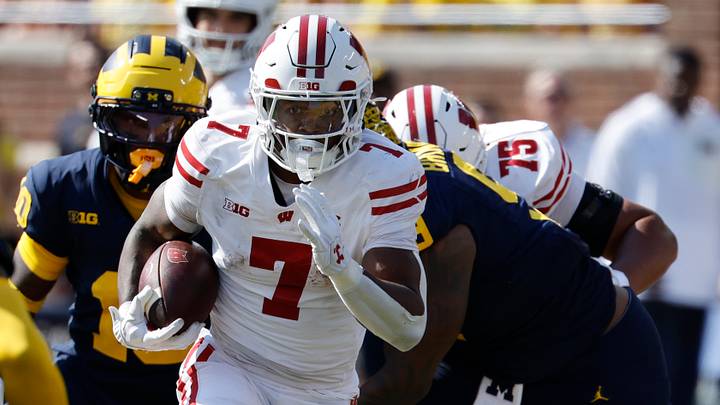 Oct 4, 2025; Ann Arbor, Michigan, USA; Wisconsin Badgers running back Dilin Jones (7) rushes in the first half against the Michigan Wolverines at Michigan Stadium. Mandatory Credit: Rick Osentoski-Imagn Images Oct 4, 2025; Ann Arbor, Michigan, USA; Wisconsin Badgers running back Dilin Jones (7) rushes in the first half against the Michigan Wolverines at Michigan Stadium. Mandatory Credit: Rick Osentoski-Imagn Images