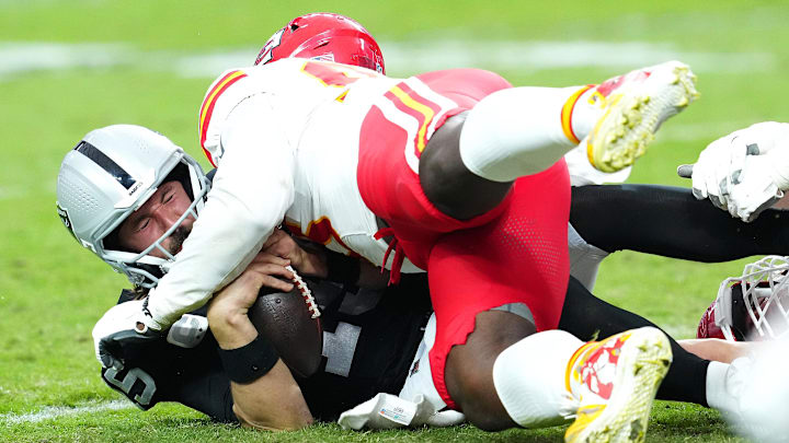 Oct 27, 2024; Paradise, Nevada, USA; Las Vegas Raiders quarterback Gardner Minshew (15) is sacked by Kansas City Chiefs defensive tackle Tershawn Wharton (98) during the third quarter at Allegiant Stadium. Mandatory Credit: Stephen R. Sylvanie-Imagn Images