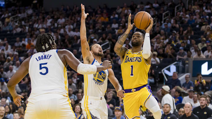 Oct 7, 2023; San Francisco, California, USA; Golden State Warriors guard Stephen Curry (30) defends Los Angeles Lakers guard D'Angelo Russell (1) during the first half at Chase Center. Mandatory Credit: John Hefti-Imagn Images
