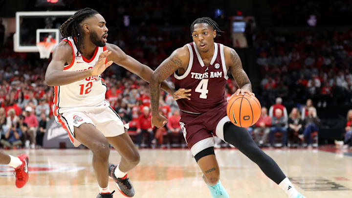 Nov 10, 2023; Columbus, Ohio, USA; Texas A&M Aggies guard Wade Taylor IV (4) dribbles the ball as Ohio State Buckeyes guard Evan Mahaffey (12) defends during the first half at Value City Arena. Mandatory Credit: Joseph Maiorana-Imagn Images Nov 10, 2023; Columbus, Ohio, USA; Texas A&M Aggies guard Wade Taylor IV (4) dribbles the ball as Ohio State Buckeyes guard Evan Mahaffey (12) defends during the first half at Value City Arena. Mandatory Credit: Joseph Maiorana-Imagn Images
