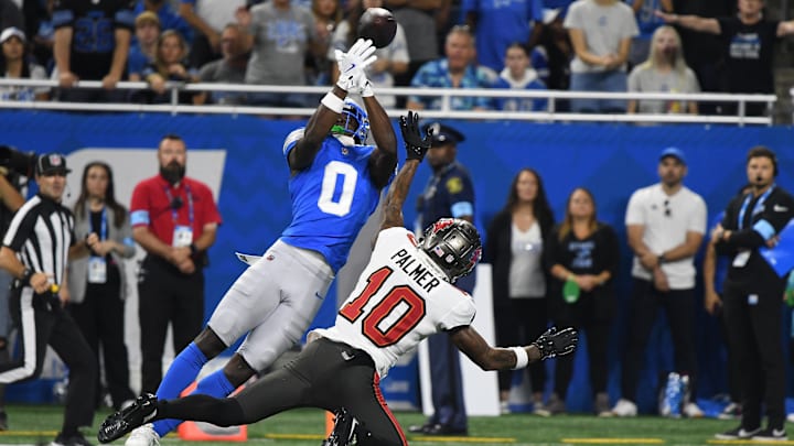 Sep 15, 2024; Detroit, Michigan, USA; Detroit Lions cornerback Terrion Arnold (0) breaks up a pass intended for Tampa Bay Buccaneers wide receiver Trey Palmer (10) in the first quarter at Ford Field. Mandatory Credit: Eamon Horwedel-Imagn Images