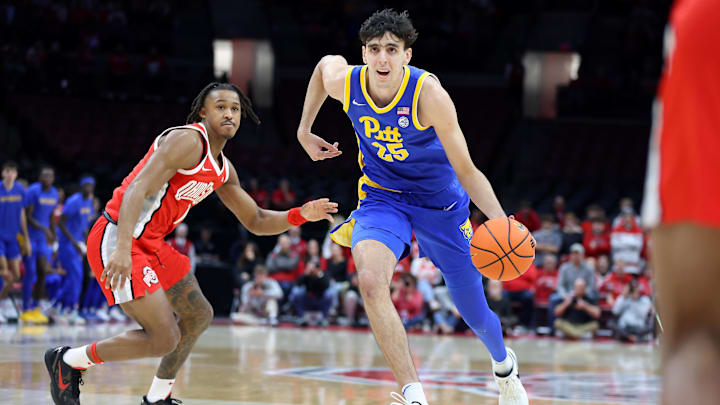 Nov 29, 2024; Columbus, Ohio, USA; Pittsburgh Panthers forward Guillermo Diaz Graham (25) drives to the basket as Ohio State Buckeyes guard Meechie Johnson Jr. (1) defends during the first half at Value City Arena. Mandatory Credit: Joseph Maiorana-Imagn Images