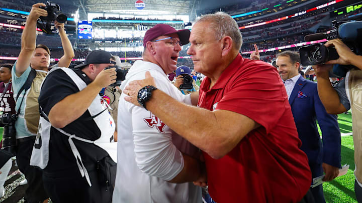 Sep 28, 2024; Arlington, Texas, USA; Texas A&M Aggies head coach Mike Elko (left) shakes hands with Arkansas Razorbacks head coach Sam Pittman (right) after the game  at AT&T Stadium.