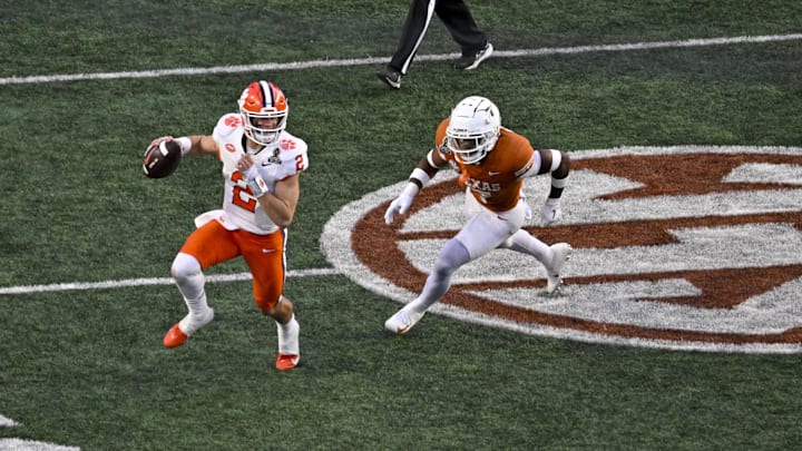 Dec 21, 2024; Austin, Texas, USA; Clemson Tigers quarterback Cade Klubnik (2) and Texas Longhorns defensive back Jahdae Barron (7) in action during the game between the Texas Longhorns and the Clemson Tigers in the CFP National Playoff First Round at Darrell K Royal-Texas Memorial Stadium. Dec 21, 2024; Austin, Texas, USA; Clemson Tigers quarterback Cade Klubnik (2) and Texas Longhorns defensive back Jahdae Barron (7) in action during the game between the Texas Longhorns and the Clemson Tigers in the CFP National Playoff First Round at Darrell K Royal-Texas Memorial Stadium.