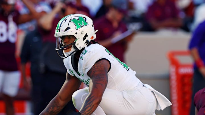Marshall Thundering Herd defensive lineman Mike Green celebrates after sacking Virginia Tech Hokies quarterback Kyron Drones. Marshall Thundering Herd defensive lineman Mike Green celebrates after sacking Virginia Tech Hokies quarterback Kyron Drones.