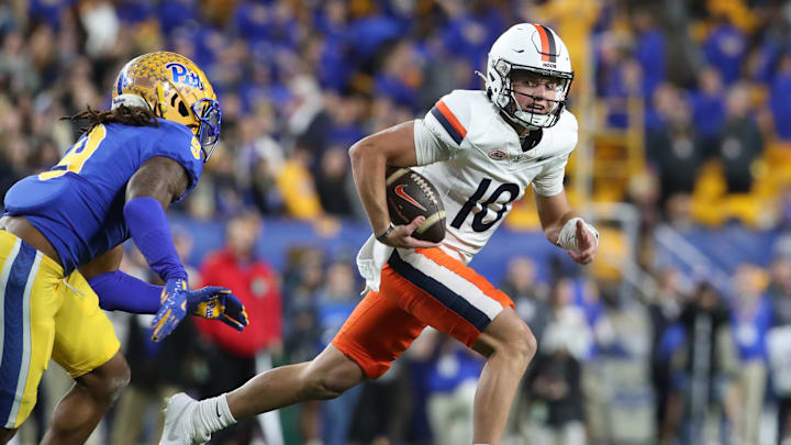 Nov 9, 2024; Pittsburgh, Pennsylvania, USA;  Virginia Cavaliers quarterback Anthony Colandrea (10) runs with the ball as Pittsburgh Panthers linebacker Kyle Louis (9) chases during the first quarter at Acrisure Stadium. Mandatory Credit: Charles LeClaire-Imagn Images