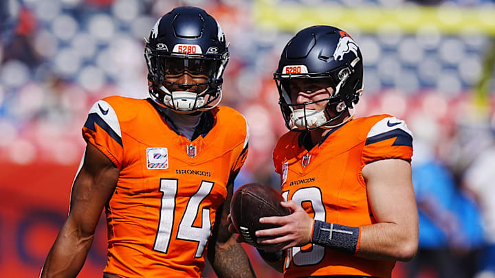 Oct 13, 2024; Denver, Colorado, USA; Denver Broncos wide receiver Courtland Sutton (14) and quarterback Bo Nix (10) warm up before the game against the Los Angeles Chargers at Empower Field at Mile High. Mandatory Credit: Ron Chenoy-Imagn Images