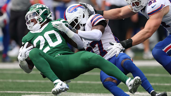 Sep 14, 2025; East Rutherford, New Jersey, USA; Buffalo Bills cornerback Tre'Davious White (27) tackles New York Jets running back Breece Hall (20) during the first half at MetLife Stadium. Mandatory Credit: Vincent Carchietta-Imagn Images