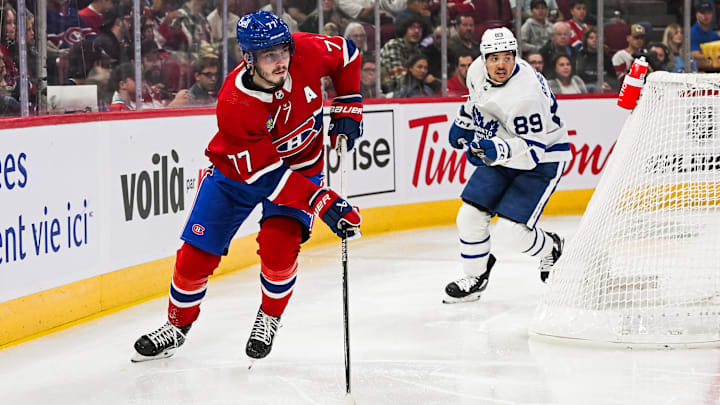 Sep 30, 2023; Montreal, Quebec, CAN; Montreal Canadiens center Kirby Dach (77) plays the puck against the Toronto Maple Leafs during the first period at Bell Centre. Mandatory Credit: David Kirouac-Imagn Images