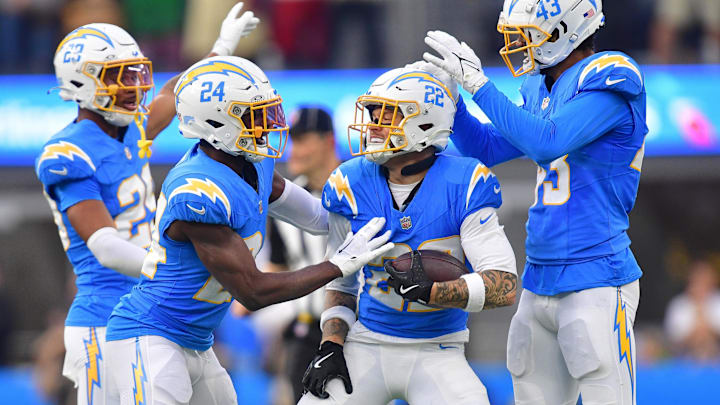 Former Husky Elijah Molden (22) celebrates with Chargers teammates  after recovering a fumble againstTampa Bay.