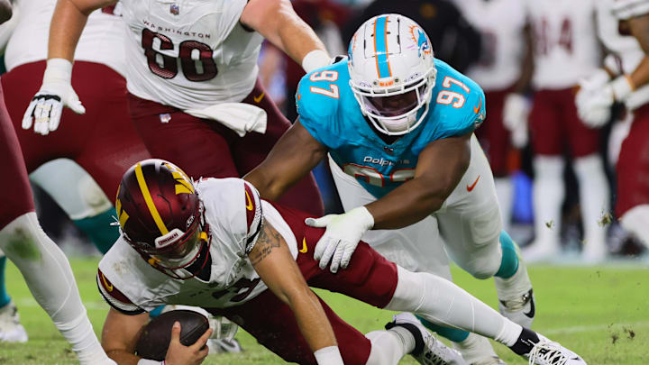Miami Dolphins defensive tackle Isaiah Mack sacks Washington Commanders quarterback Trace McSorley.