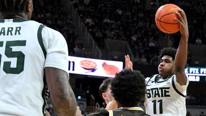 Dec 30, 2024; East Lansing, Michigan, USA;  Michigan State Spartans guard Jase Richardson (11) passes under the basket against the Western Michigan Broncos during the second half at Jack Breslin Student Events Center. Mandatory Credit: Dale Young-Imagn Images