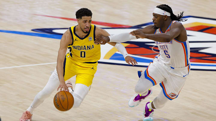 Indiana Pacers guard Tyrese Haliburton (0) drives to the basket past Oklahoma City Thunder guard Luguentz Dort (5) during the second quarter during game one of the 2025 NBA Finals at Paycom Center. 