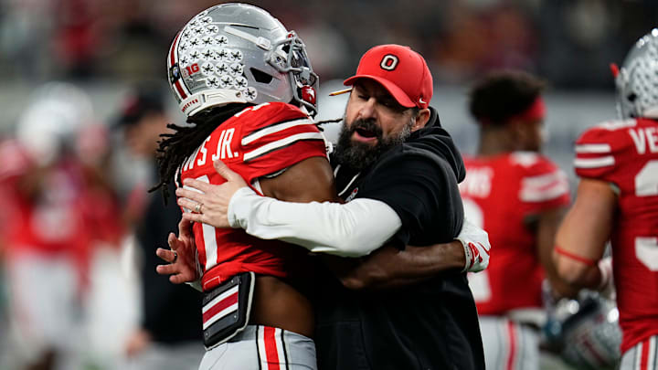 Ohio State Buckeyes defensive coordinator Matt Patricia hugs cornerback Jermaine Mathews Jr. (7) during warm-ups prior to the Cotton Bowl in Arlington, Texas for the College Football Playoff quarterfinal game against the Miami Hurricanes on Dec. 31, 2025.