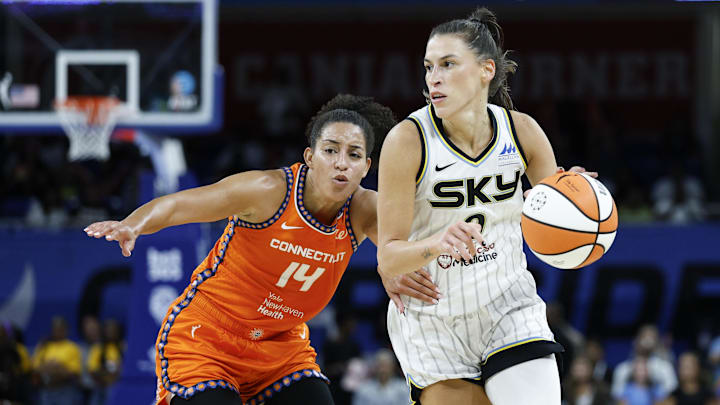 Aug 23, 2025; Chicago, Illinois, USA; Chicago Sky guard Sevgi Uzun (0) drives to the basket against Connecticut Sun guard Bria Hartley (14) during the second half at Wintrust Arena. Mandatory Credit: Kamil Krzaczynski-Imagn Images