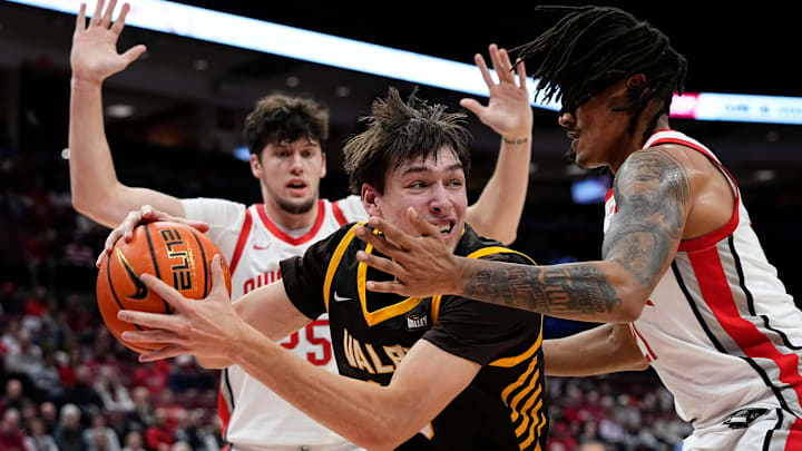 Ohio State Buckeyes forward Devin Royal (21) defends Valparaiso Beacons forward Cooper Schwieger (13) during the during the first half of the NCAA men's basketball game at Value City Arena in Columbus on Dec. 17, 2024.