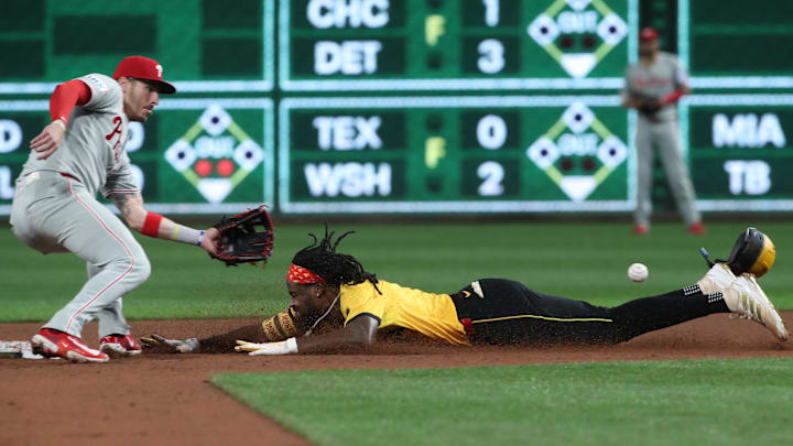 Jun 6, 2025; Pittsburgh, Pennsylvania, USA;  Pittsburgh Pirates center fielder Oneil Cruz (right) beats the throw to Philadelphia Phillies second baseman Bryson Stott (left) on a steal attempt but was ruled out on batter interference  during the fifth inning at PNC Park. Mandatory Credit: Charles LeClaire-Imagn Images