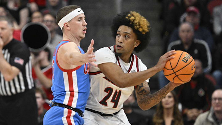 Dec 3, 2024; Louisville, Kentucky, USA;  Louisville Cardinals guard Chucky Hepburn (24) looks to pass under the pressure of Mississippi Rebels guard Sean Pedulla (3) during the first half at KFC Yum! Center. Mandatory Credit: Jamie Rhodes-Imagn Images