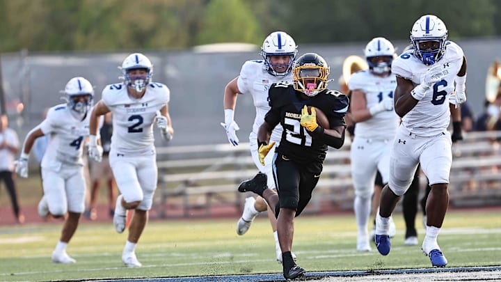 Moeller running back carries the ball during their football game against St. Xavier Friday, Sept. 19, 2025.