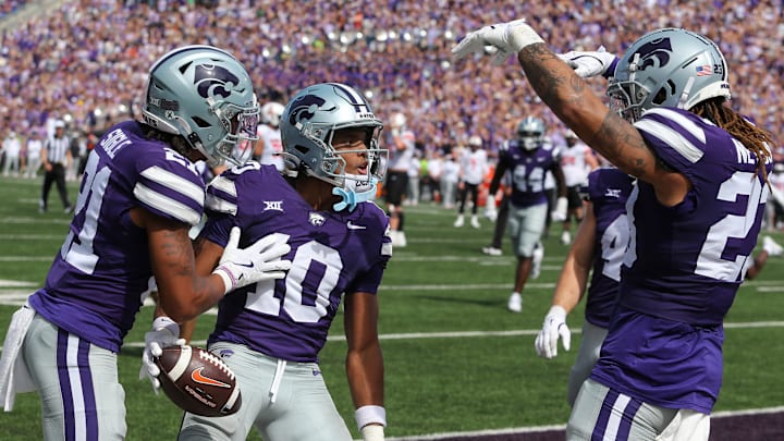 Sep 28, 2024; Manhattan, Kansas, USA; Kansas State Wildcats cornerback Jacob Parrish (10) celebrates with safety Marques Sigle (21) and linebacker Asa Newsom (23) after intercepting a pass against the Oklahoma State Cowboys in the third quarter at Bill Snyder Family Football Stadium. Mandatory Credit: Scott Sewell-Imagn Images