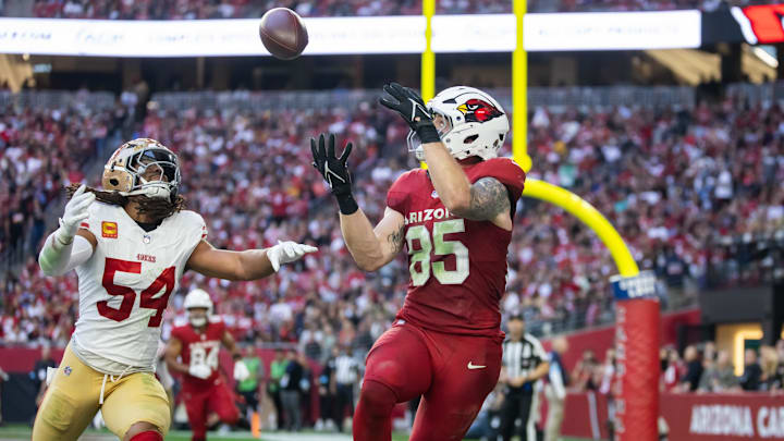 Jan 5, 2025; Glendale, Arizona, USA; Arizona Cardinals tight end Trey McBride (85) catches a touchdown pass against San Francisco 49ers linebacker Fred Warner (54) in the first half at State Farm Stadium. Mandatory Credit: Mark J. Rebilas-Imagn Images