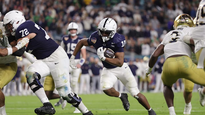 Penn State Nittany Lions running back Nicholas Singleton (10) runs the ball in the second half against the Notre Dame Fighting Irish  in the Orange Bowl at Hard Rock Stadium.