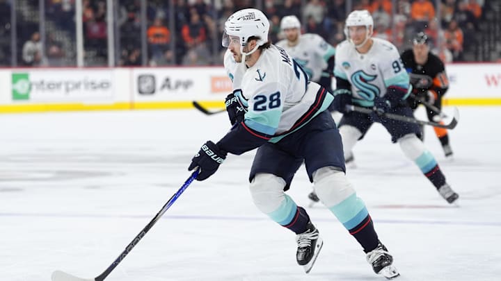 Mar 8, 2025; Philadelphia, Pennsylvania, USA; Seattle Kraken defenseman Josh Mahura (28) controls the puck against the Philadelphia Flyers in the third period at Wells Fargo Center. Mandatory Credit: Kyle Ross-Imagn Images