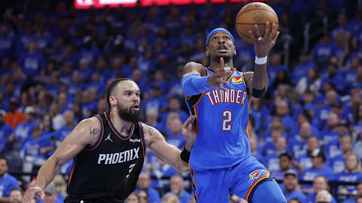 Apr 19, 2026; Oklahoma City, Oklahoma, USA; Oklahoma City Thunder guard Shai Gilgeous-Alexander (2) goes up for a basket beside Phoenix Suns forward Dillon Brooks (3) in the second half during game one of the first round of the 2026 NBA Playoffs at Paycom Center. Mandatory Credit: Alonzo Adams-Imagn Images