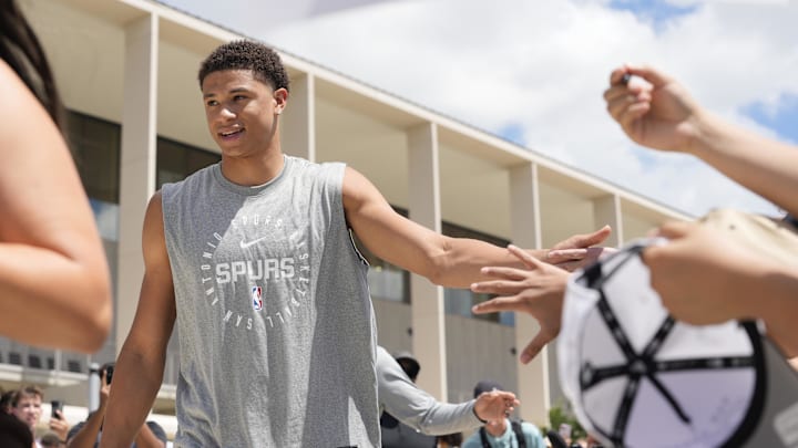 Jun 28, 2025; San Antonio, TX, USA; San Antonio Spurs first round draft pick Carter Bryant greets fans at Victory Capital Performance Center. Mandatory Credit: Scott Wachter-Imagn Images