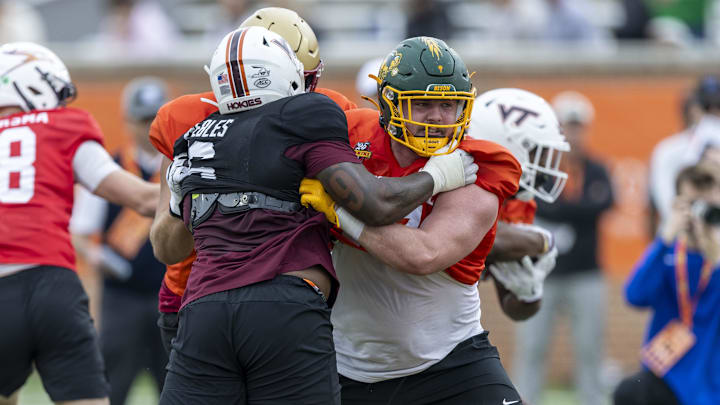 Jan 30, 2025; Mobile, AL, USA; National team defensive lineman Aeneas Peebles of Virginia Tech (16) battles National team offensive lineman Grey Zabel of North Dakota State (77) during Senior Bowl practice for the National team at Hancock Whitney Stadium. 