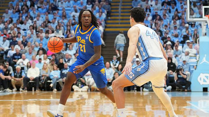 Feb 14, 2026; Chapel Hill, North Carolina, USA; Pittsburgh Panthers guard MacAri Moore (21) with the ball as North Carolina Tar Heels guard Luka Bogavac (44) defends in the first half at Dean E. Smith Center. Mandatory Credit: Bob Donnan-Imagn Images Feb 14, 2026; Chapel Hill, North Carolina, USA; Pittsburgh Panthers guard MacAri Moore (21) with the ball as North Carolina Tar Heels guard Luka Bogavac (44) defends in the first half at Dean E. Smith Center. Mandatory Credit: Bob Donnan-Imagn Images