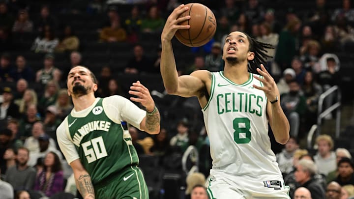 Dec 11, 2025; Milwaukee, Wisconsin, USA; Boston Celtics forward Josh Minott (8) looks for a shot against Milwaukee Bucks guard Cole Anthony (50) in the fourth quarter at Fiserv Forum.