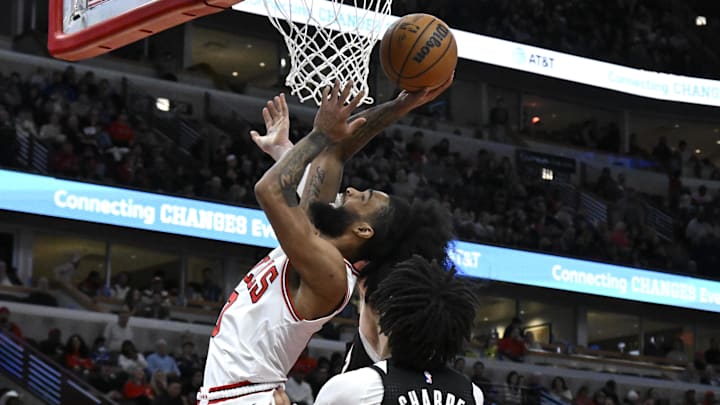 Apr 4, 2025; Chicago, Illinois, USA: Chicago Bulls guard Coby White (0) shoots against Portland Trail Blazers guard Shaedon Sharpe (17) and center Donovan Clingan (23) during the second half at the United Center. Mandatory Credit: Matt Marton-Imagn Images Apr 4, 2025; Chicago, Illinois, USA: Chicago Bulls guard Coby White (0) shoots against Portland Trail Blazers guard Shaedon Sharpe (17) and center Donovan Clingan (23) during the second half at the United Center. Mandatory Credit: Matt Marton-Imagn Images