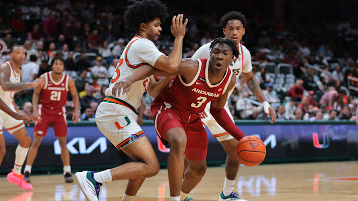 Dec 3, 2024; Coral Gables, Florida, USA; Arkansas Razorbacks forward Adou Thiero (3) drives to the basket against Miami Hurricanes guard Austin Swartz (23) during the first half at Watsco Center. Mandatory Credit: Sam Navarro-Imagn Images Dec 3, 2024; Coral Gables, Florida, USA; Arkansas Razorbacks forward Adou Thiero (3) drives to the basket against Miami Hurricanes guard Austin Swartz (23) during the first half at Watsco Center. Mandatory Credit: Sam Navarro-Imagn Images
