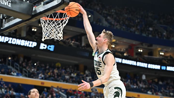 Mar 19, 2026; Buffalo, NY, USA; Michigan State Spartans center Carson Cooper (15) dunks during the second half against the North Dakota State Bison during a first round game of the men's 2026 NCAA Tournament at Keybank Center. Mandatory Credit: Mark Konezny-Imagn Images