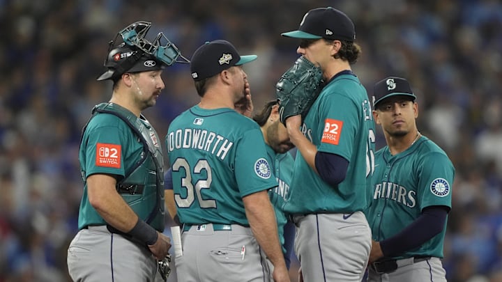 Oct 19, 2025; Toronto, Ontario, CAN; Seattle Mariners catcher Cal Raleigh (29) and pitching coach Pete Woodworth (32) visit Seattle Mariners pitcher Logan Gilbert (36) on the mound in the second inning during game six of the ALCS round for the 2025 MLB playoffs at Rogers Centre. Mandatory Credit: John E. Sokolowski-Imagn Images