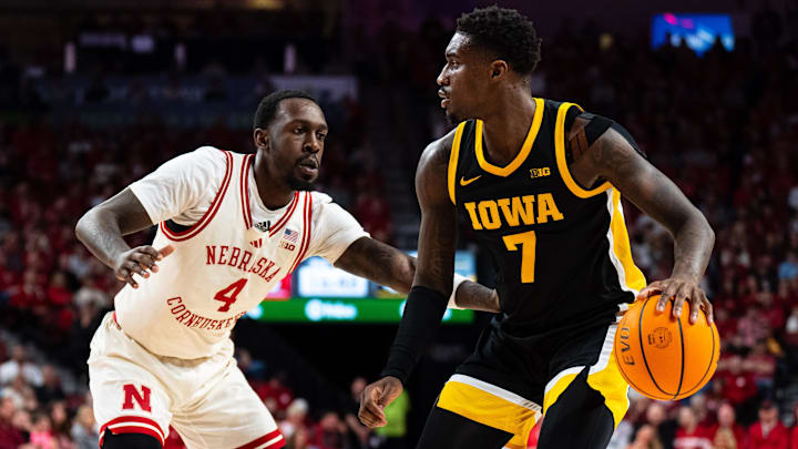 Mar 9, 2025; Lincoln, Nebraska, USA; Iowa Hawkeyes forward Seydou Traore (7) drives against Nebraska Cornhuskers forward Juwan Gary (4) during the second half at Pinnacle Bank Arena. Mandatory Credit: Dylan Widger-Imagn Images