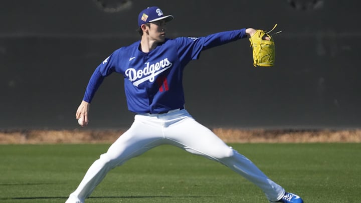 Feb 14, 2026; Glendale, AZ, USA; Los Angeles Dodgers pitcher Roki Sasaki (11) throws long ball during spring training camp. Mandatory Credit: Rick Scuteri-Imagn Images