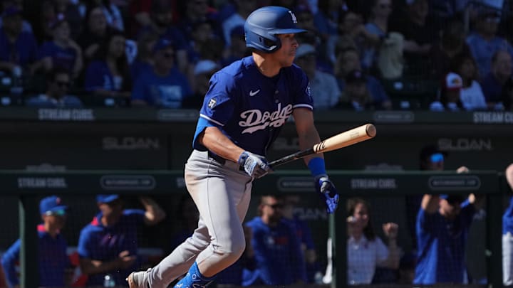 Feb 21, 2025; Mesa, Arizona, USA; Los Angeles Dodgers outfielder Tommy Edman (25) hits a single against the Chicago Cubs during the third inning at Sloan Park. Mandatory Credit: Rick Scuteri-Imagn Images