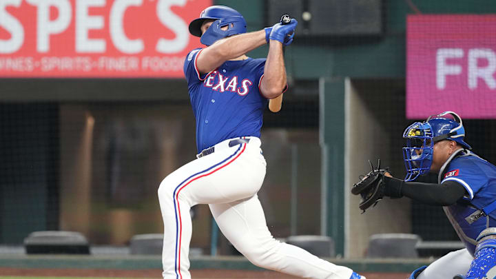 Mar 25, 2025; Arlington, Texas, USA; Texas Rangers left fielder Wyatt Langford (36) follows through on his single against the Kansas City Royals in the third inning at Globe Life Field. 