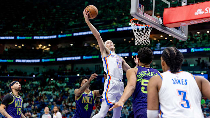 Apr 13, 2025; New Orleans, Louisiana, USA; Oklahoma City Thunder center Branden Carlson (15) grabs a rebound against New Orleans Pelicans guard Elfrid Payton (4) during the first half at Smoothie King Center. Mandatory Credit: Stephen Lew-Imagn Images Apr 13, 2025; New Orleans, Louisiana, USA; Oklahoma City Thunder center Branden Carlson (15) grabs a rebound against New Orleans Pelicans guard Elfrid Payton (4) during the first half at Smoothie King Center. Mandatory Credit: Stephen Lew-Imagn Images