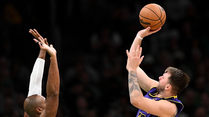 Mar 8, 2025; Boston, Massachusetts, USA; Los Angeles Lakers guard Luka Doncic (77) takes a shot past Boston Celtics center Al Horford (42) during the fourth quarter at the TD Garden. Mandatory Credit: Brian Fluharty-Imagn Images Mar 8, 2025; Boston, Massachusetts, USA; Los Angeles Lakers guard Luka Doncic (77) takes a shot past Boston Celtics center Al Horford (42) during the fourth quarter at the TD Garden. Mandatory Credit: Brian Fluharty-Imagn Images