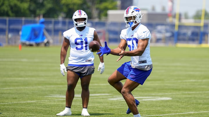 Buffalo Bills DE Greg Rousseau makes a catch with DT Ed Oliver looking on during Minicamp at Highmark Stadium.