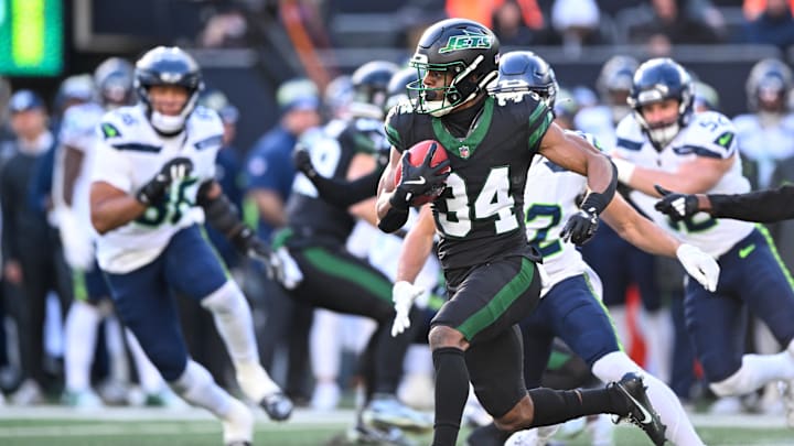 Dec 1, 2024; East Rutherford, New Jersey, USA; New York Jets running back Kene Nwangwu (34) returns a kickoff for a touchdown during the second quarter against the Seattle Seahawks at MetLife Stadium. Dec 1, 2024; East Rutherford, New Jersey, USA; New York Jets running back Kene Nwangwu (34) returns a kickoff for a touchdown during the second quarter against the Seattle Seahawks at MetLife Stadium.