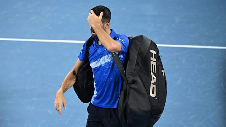 Novak Djokovic is seen walking off court after losing to Reilly Opelka in the Brisbane International quarterfinals. Novak Djokovic is seen walking off court after losing to Reilly Opelka in the Brisbane International quarterfinals.