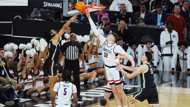 Connecticut Huskies center Donovan Clingan (32) blocks Purdue Boilermakers forward Trey Kaufman-Renn (4) in the first half in the national championship game of the Final Four of the 2024 NCAA Tournament at State Farm Stadium in Glendale on April 8, 2024.
