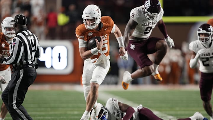 Texas Longhorns quarterback Arch Manning keeps the ball and runs for a touchdown during the second half against the Texas A&M Aggies at Darrell K Royal-Texas Memorial Stadium.