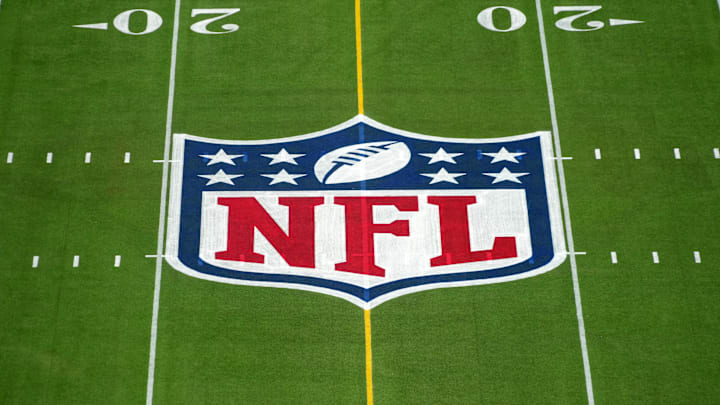 An overall view of the NFL shield logo at midfield on the Camping World Stadium flag football field. 