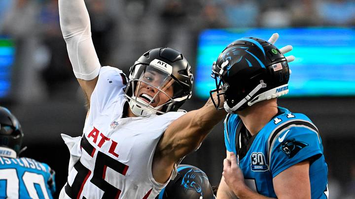 Oct 13, 2024; Charlotte, North Carolina, USA;  Carolina Panthers quarterback Andy Dalton (14) passes the ball as Atlanta Falcons linebacker Kaden Elliss (55) pressures in the second quarter at Bank of America Stadium. Mandatory Credit: Bob Donnan-Imagn Images