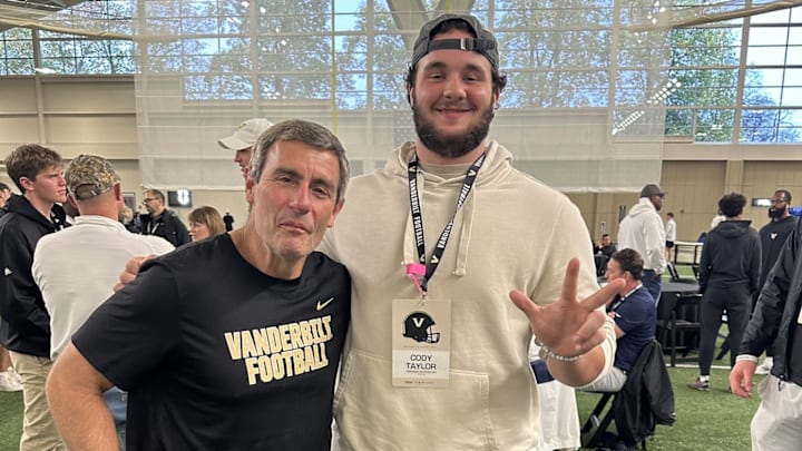 Greenwood offensive lineman Cody Taylor poses for a photo, during a recruiting trip to Vanderbilt, with the Commodore's offensive line coach Chris Klenakis.